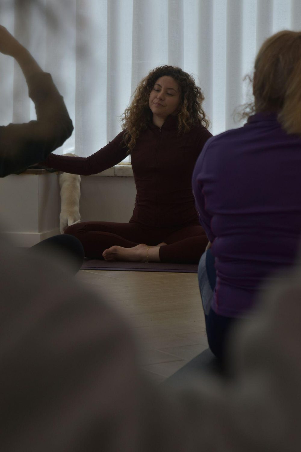 People seated cross-legged in a guided practice