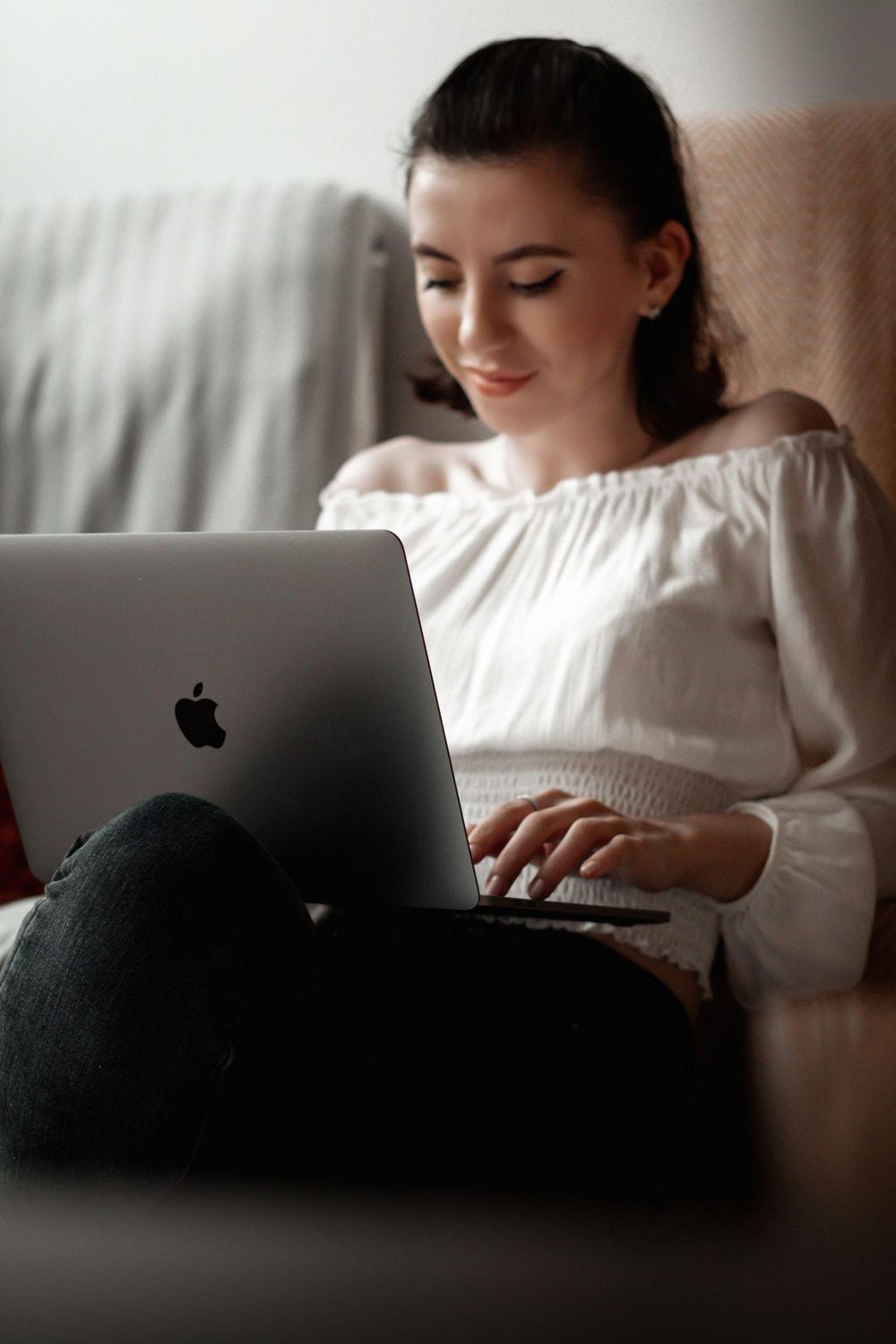 A woman joining a session from her sofa
