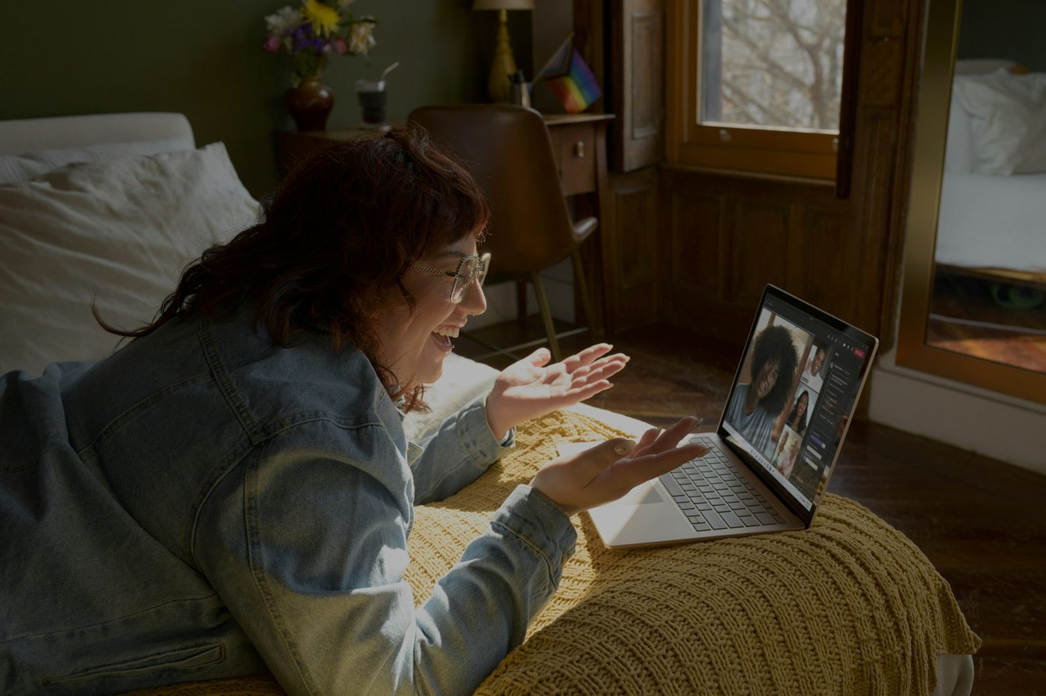 A woman in a video session with her therapist, at home