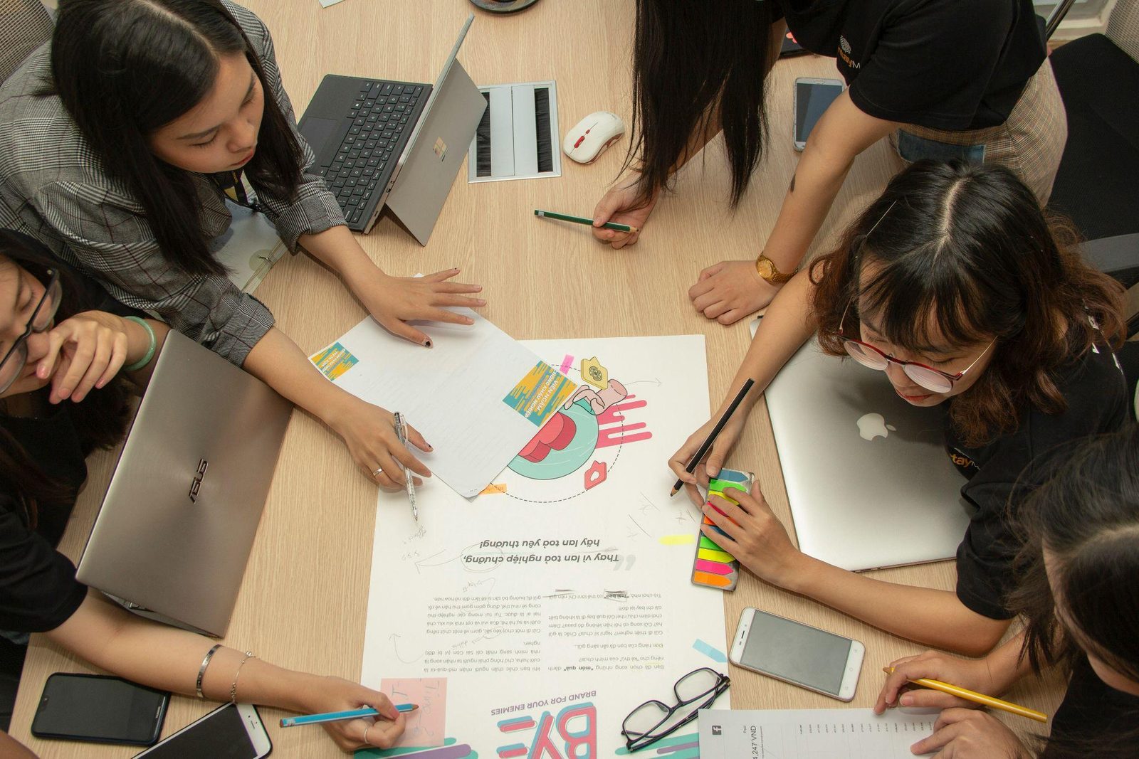 A group working together over notes spread across a table
